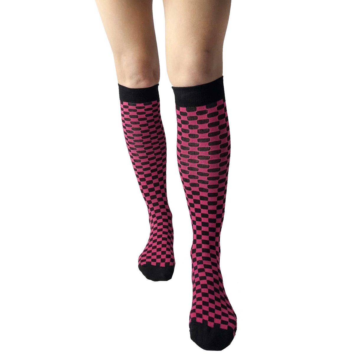 Women's fuchsia pink and black checkered knee-high socks with a warped checkerboard design, soft knit fabric, and alternative fashion style.