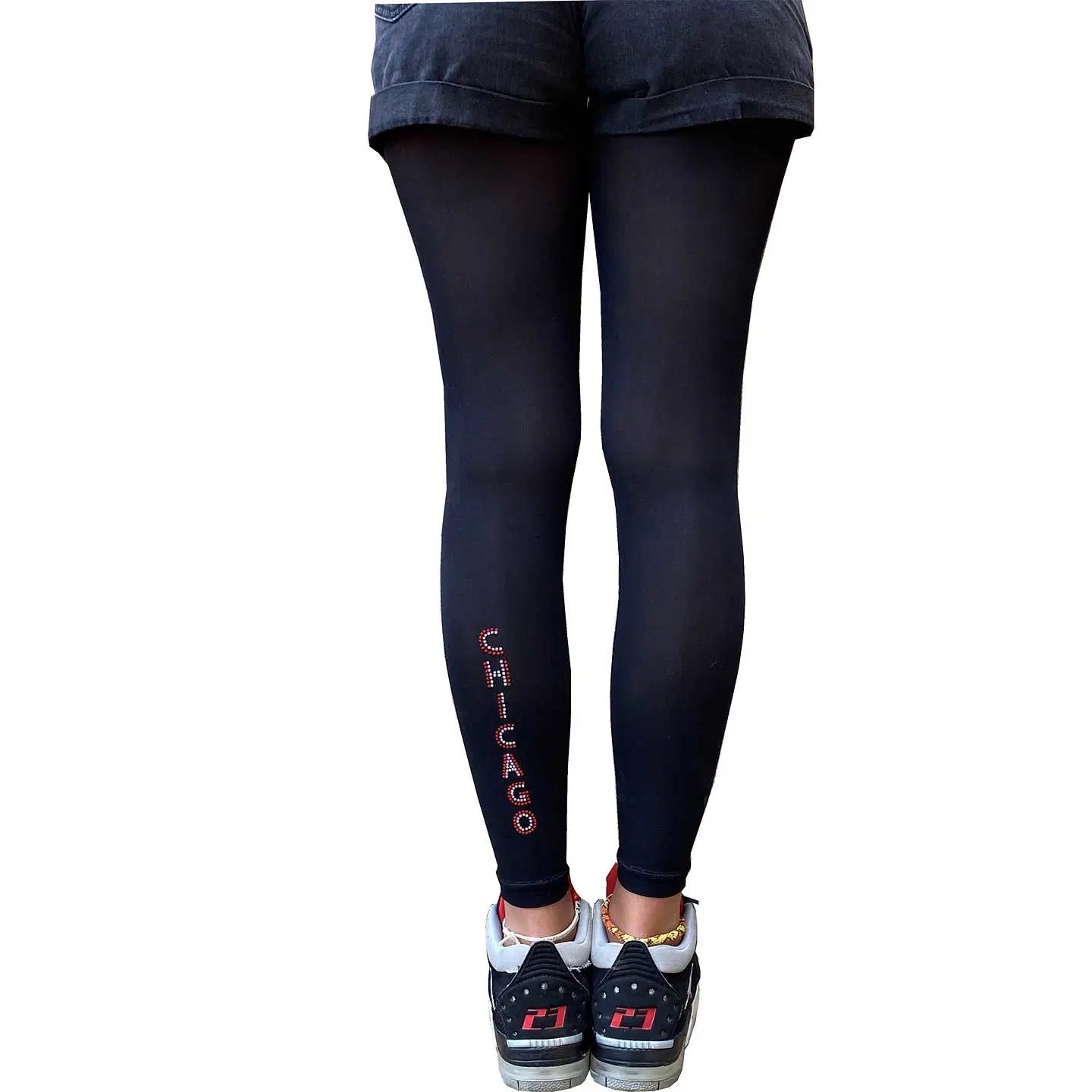 Chicago-inspired black footless tights with edgy stud details and sleek opaque finish