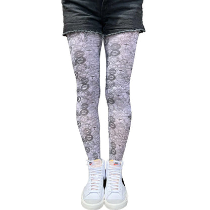 Black white patterned tights with stamp motif by Malka Chic