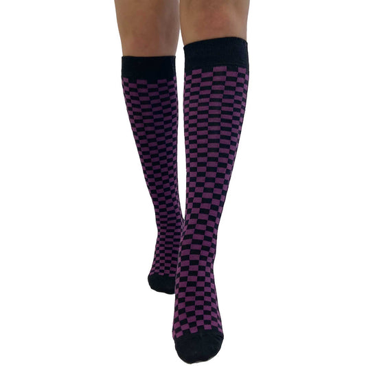 Women's purple and black checkered knee-high socks with a warped checkerboard design, soft knit fabric, and alternative fashion style.