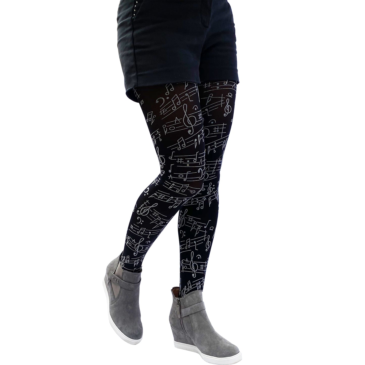 Close-up of black tights with music note design