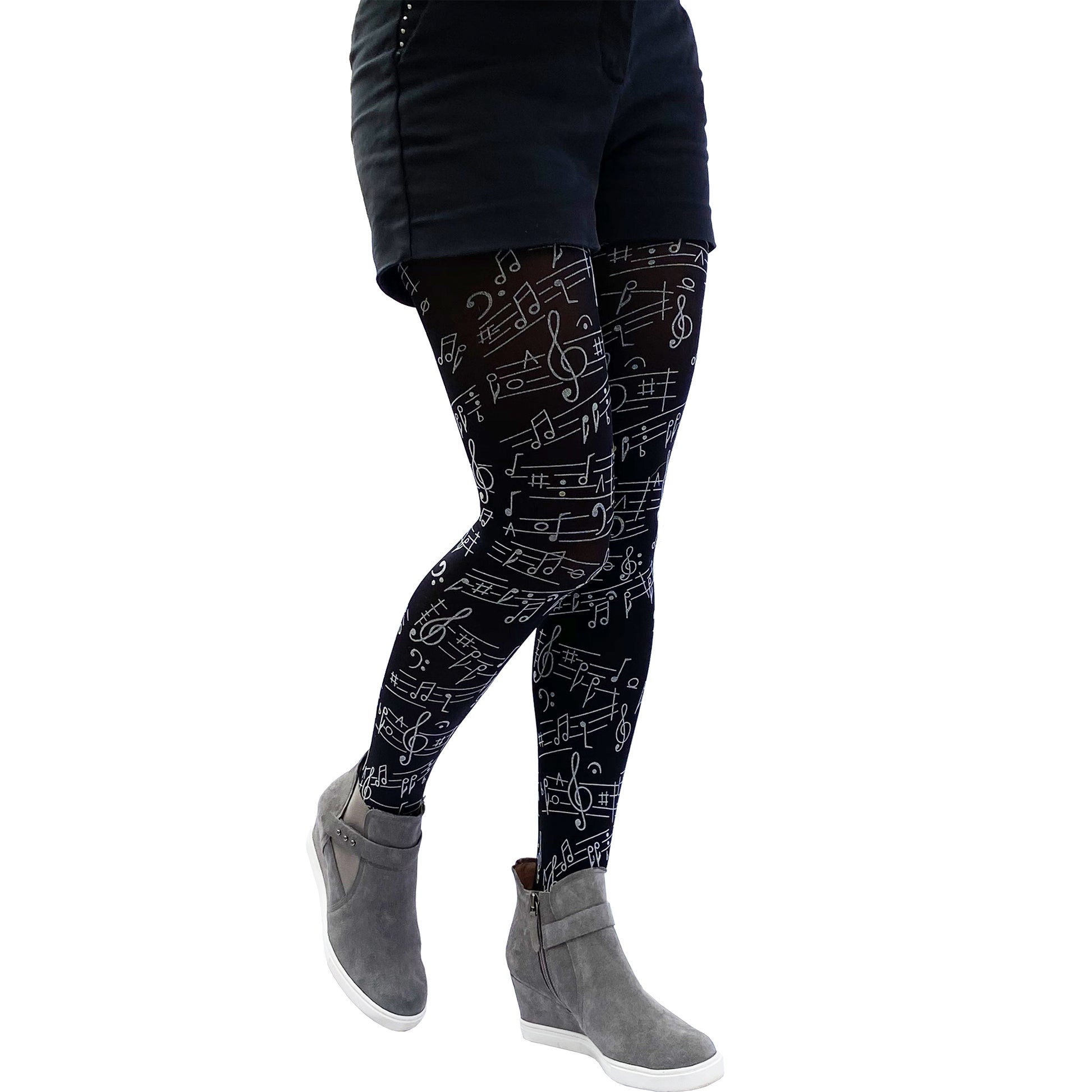 Close-up of black tights with music note design