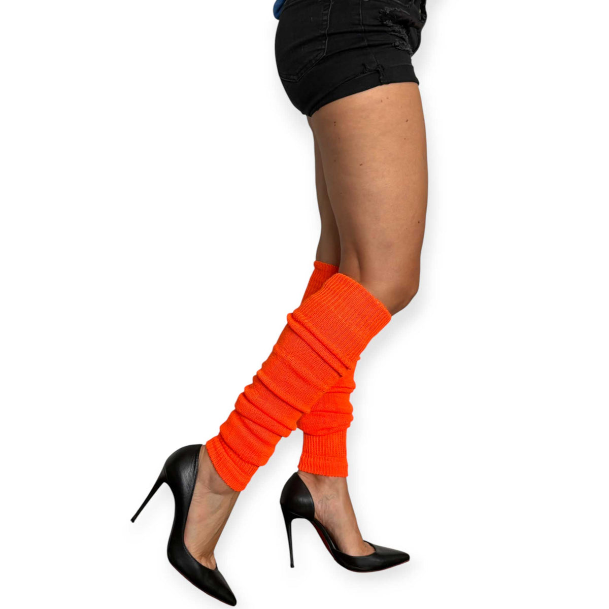 Women’s neon orange leg warmers with black shorts and floral pumps.