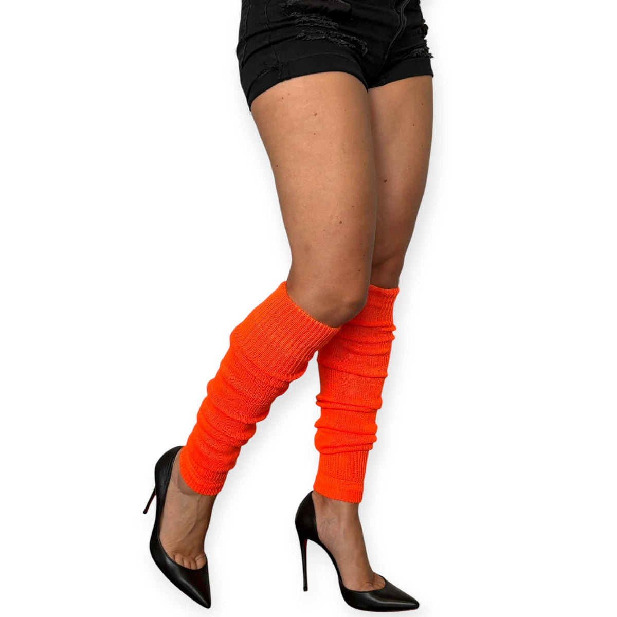 Hot orange knitted leg warmers styled as a bold fashion accessory.