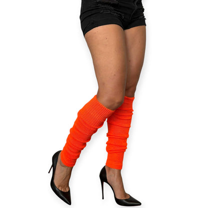Hot orange knitted leg warmers styled as a bold fashion accessory.