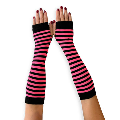 Long bright pink and black striped arm warmers for women by Malka Chic with fingerless glove design.