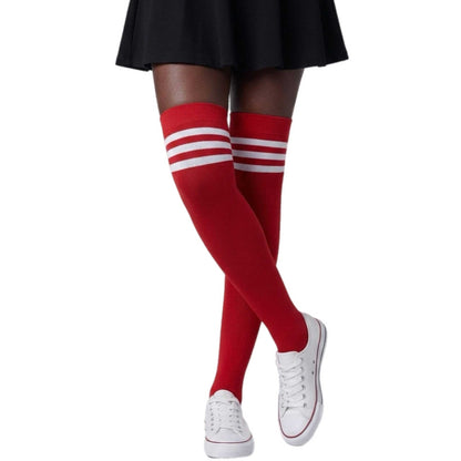 Woman wearing red over-the-knee socks with three white stripes at the top by Malka Chic.