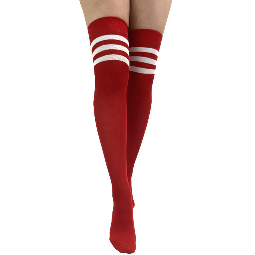 Red thigh-high socks with white athletic stripes styled as fashionable over-the-knee socks for women.