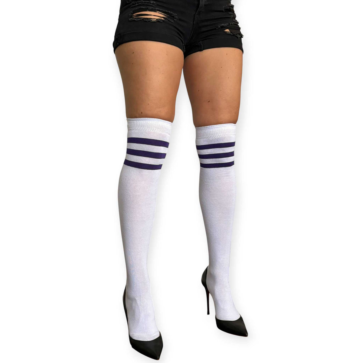 White over the knee socks for women by Malka Chic with purple stripes near the top, styled with black shorts and pointed heels.