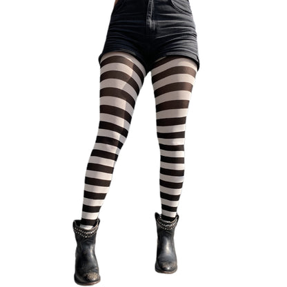 White and Black striped tights worn with a black short sold at Malka Chic 2