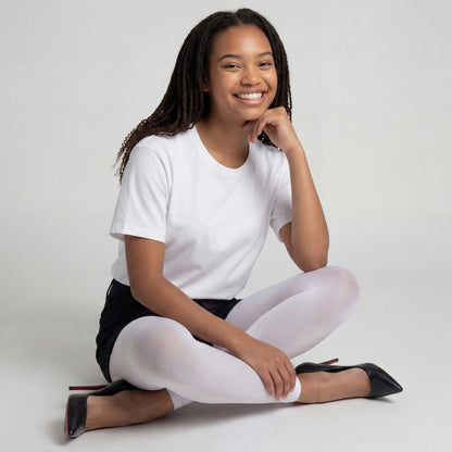 Woman sitting on the floor wearing a Woman wearing a Comfortable white footless tights designed for versatile styling and all-day wear