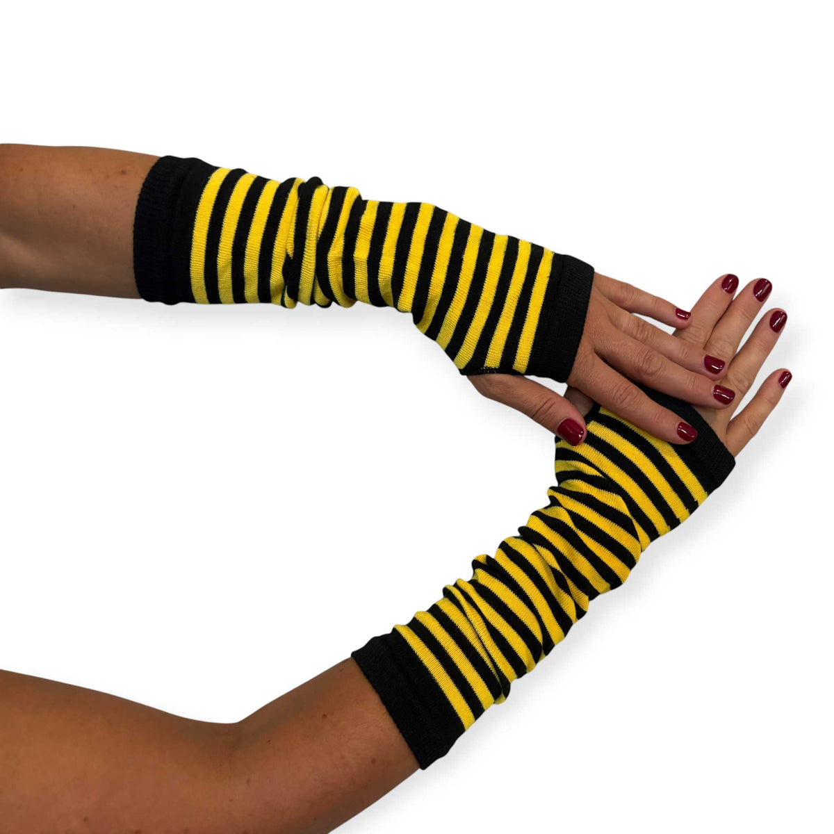 Yellow and black striped fingerless gloves for women by Malka Chic with long arm warmer styling.